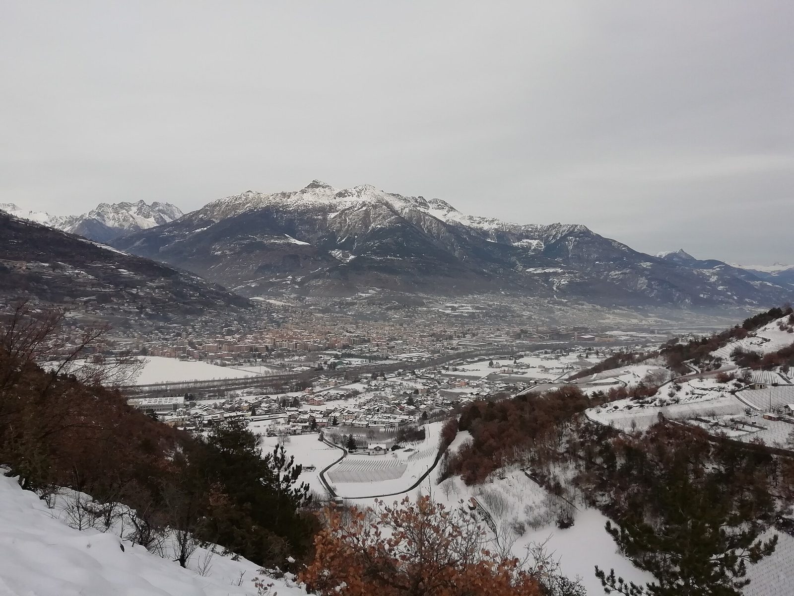 La conca di Aosta innevata vista dall'alto, con i villaggi, i vigneti e le montagne sullo sfondo